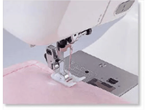Brother sewing machine presser foot stitching pink fabric with automatic needle threader