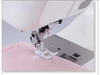 Brother sewing machine presser foot stitching pink fabric with automatic needle threader