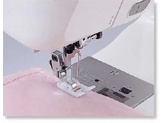 Brother sewing machine presser foot stitching pink fabric with automatic needle threader