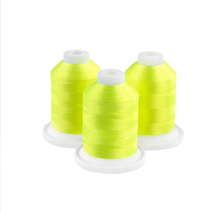 Brother embroidery thread spools in neon yellow with white caps on white background